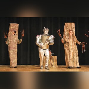 Tin Man (Richard Davis) sings with Stephanie McCarthy, left, and Cadence Keene, who are portraying trees in the forest.