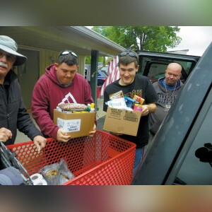Working at the White County Food Pantry, Dakota Denton (left) and Kyler Hardesty grab boxes from a shopping cart to put into Charles Fetton’s vehicle. Fetton is from Monticello. Photo by W.C. Madden/News & Review