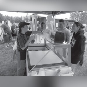 Natalie Kennedy hands an ice cream to a customer at the Patio Drive-In booth. The restaurant is in Francesville.
