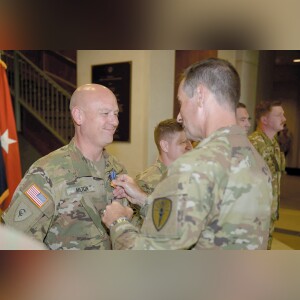 Indiana National Guard Chief Warrant Officer Brett Milton, a 38th Combat Aviation Brigade pilot from Monticello, receives the Indiana Distinguished Service Cross from Brig. Gen. Larry Muennich, Indiana’s adjutant general, during a ceremony at Stout Field in Indianapolis on Sept. 12. Milton received the award for helping to save lives during Kentucky floods in February. Photo by M/Sgt. Jeff Lowry